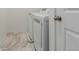 Laundry room with modern, white, front-loading washer and dryer at 870 Mosquito Ct, Elizabeth, CO 80107