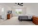 Light filled primary bedroom with neutral carpet, ceiling fan, and walk-in closet at 870 Mosquito Ct, Elizabeth, CO 80107