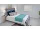 Bedroom featuring a modern wood bed frame, side tables, and soft natural light at 815 Plum Ave, Lochbuie, CO 80603