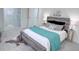Bedroom with a rustic wood bed frame and a nearby walk-in closet at 815 Plum Ave, Lochbuie, CO 80603