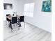 Light-filled dining room features a table set for four with wood flooring and modern decor at 815 Plum Ave, Lochbuie, CO 80603