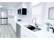 Bright kitchen with stainless steel appliances, white cabinets and sink at 815 Plum Ave, Lochbuie, CO 80603