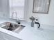 The modern kitchen sink with stainless steel faucet and white countertops at 815 Plum Ave, Lochbuie, CO 80603