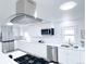 Bright kitchen with stainless steel appliances, white cabinetry, and granite countertops at 815 Plum Ave, Lochbuie, CO 80603