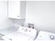 Laundry room with white washer, dryer, quartz countertop, and white cabinet at 815 Plum Ave, Lochbuie, CO 80603