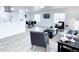 Spacious living room featuring open concept with kitchen and dining areas, natural light, and modern decor at 815 Plum Ave, Lochbuie, CO 80603