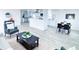 Open-concept living area with sleek furnishings and view of modern kitchen at 815 Plum Ave, Lochbuie, CO 80603