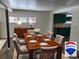 Formal dining area features a wood table, upholstered chairs, and a sideboard with bright natural light at 11967 W Ranch Elsie Rd, Golden, CO 80403