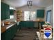 Eat-in kitchen with natural wood countertops, green cabinets, and stainless steel appliances at 11967 W Ranch Elsie Rd, Golden, CO 80403