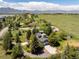 Aerial view of a modern home with lush green landscaping and open field behind it at 6843 Fairview Dr, Boulder, CO 80303