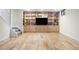 Finished basement area with built-in shelving, entertainment center, and hardwood floors at 6843 Fairview Dr, Boulder, CO 80303