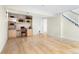 Finished basement area with built-in shelving, desk, and hardwood floors at 6843 Fairview Dr, Boulder, CO 80303