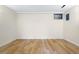 Finished basement area with hardwood floors and a small window at 6843 Fairview Dr, Boulder, CO 80303