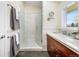 Bathroom featuring a glass shower door, vanity, and a bright window at 6843 Fairview Dr, Boulder, CO 80303