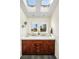 Bright bathroom featuring double sinks, wood cabinets, natural light through two windows and two skylights at 6843 Fairview Dr, Boulder, CO 80303