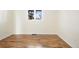 A bedroom with hardwood floors, base trim, and a window at 6843 Fairview Dr, Boulder, CO 80303