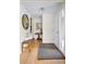 Inviting entryway featuring a wood bench, decorative rug, and a striking round mirror to add to the decor at 6843 Fairview Dr, Boulder, CO 80303