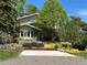 Charming two-story home with landscaped yard and colorful flowerbeds leading to the front entrance at 6843 Fairview Dr, Boulder, CO 80303
