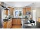 Well-appointed kitchen with wood cabinets, granite countertops, and a stainless steel sink under a large window at 6843 Fairview Dr, Boulder, CO 80303