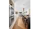 Open kitchen with stainless steel double oven and island counter with seating at 6843 Fairview Dr, Boulder, CO 80303
