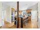 Bright kitchen features stainless steel appliances, island with seating, and hardwood floors at 6843 Fairview Dr, Boulder, CO 80303