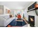 Cozy living room boasts a modern fireplace, stylish furniture, and a view into the adjacent sitting room at 6843 Fairview Dr, Boulder, CO 80303