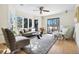 Sun-drenched living room featuring a plush sofa, elegant chairs, and large windows overlooking the backyard at 6843 Fairview Dr, Boulder, CO 80303