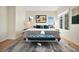 A large, sunlit main bedroom with large windows, a bed, and a decorative rug at 6843 Fairview Dr, Boulder, CO 80303