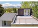 This roof deck features mountain views, a black metal safety railing and a two door entryway at 6843 Fairview Dr, Boulder, CO 80303