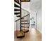 A modern black spiral staircase with wood treads leads to other levels within this stylish home at 6843 Fairview Dr, Boulder, CO 80303