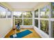 Bright sunroom with many windows offering tree and mountain views, perfect for yoga or relaxation at 6843 Fairview Dr, Boulder, CO 80303