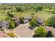Stunning aerial view of homes on a cul-de-sac with golf course and lush green landscape at 8806 Tuscany Ln, Highlands Ranch, CO 80130