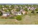 Expansive aerial perspective of a residential area, featuring homes nestled amidst lush landscaping at 8806 Tuscany Ln, Highlands Ranch, CO 80130