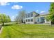 Large, grassy backyard with mature trees, a spacious patio and easy access to the house at 8806 Tuscany Ln, Highlands Ranch, CO 80130