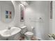 A well-lit half bathroom featuring a decorative mirror, a modern toilet, and updated hardware at 8806 Tuscany Ln, Highlands Ranch, CO 80130