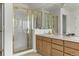 Bathroom with double sinks, a shower behind framed glass doors and a white tiled counter at 8806 Tuscany Ln, Highlands Ranch, CO 80130