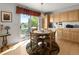 Cozy breakfast nook with natural wood cabinetry, stainless steel appliances, and access to outdoor patio at 8806 Tuscany Ln, Highlands Ranch, CO 80130