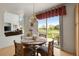 Breakfast nook with patio access offers stunning views of the surrounding green landscape and natural lighting at 8806 Tuscany Ln, Highlands Ranch, CO 80130