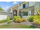 Close up view of a charming two-story home with brick accents and lush landscaping at 8806 Tuscany Ln, Highlands Ranch, CO 80130