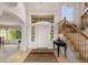 Bright foyer with hardwood floors, staircase, and large windows flooding the space with light at 8806 Tuscany Ln, Highlands Ranch, CO 80130