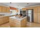 Functional kitchen with stainless steel appliances, wooden cabinets, and a tile island at 8806 Tuscany Ln, Highlands Ranch, CO 80130