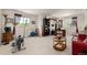 Open loft featuring a sitting area with workout equipment, desk and a view to the outdoors at 8806 Tuscany Ln, Highlands Ranch, CO 80130