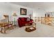 Cozy loft featuring a red sofa, rocking chair, and view of the home's entryway at 8806 Tuscany Ln, Highlands Ranch, CO 80130