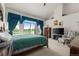 Large main bedroom with vaulted ceiling, TV area, and large windows overlooking scenic landscape at 8806 Tuscany Ln, Highlands Ranch, CO 80130