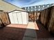 A small back yard features a storage shed, privacy fencing, and an access gate at 3081 W 18Th Ave, Denver, CO 80204