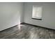 Empty room with a large window that offers ample natural lighting and gray laminate flooring at 3081 W 18Th Ave, Denver, CO 80204