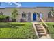 Charming home featuring a lush green lawn, landscaped garden, and inviting front entrance with a bright blue door at 3081 W 18Th Ave, Denver, CO 80204