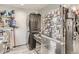 The kitchen features a washer/dryer in addition to a stainless steel fridge and stocked shelving at 3081 W 18Th Ave, Denver, CO 80204