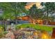 Expansive backyard with a multi-level deck, hot tub, and serene waterfall feature for ultimate relaxation at 20520 E Regency Way, Parker, CO 80138
