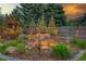 Serene backyard waterfall feature surrounded by lush plants and ambient lighting, creating a peaceful retreat at 20520 E Regency Way, Parker, CO 80138